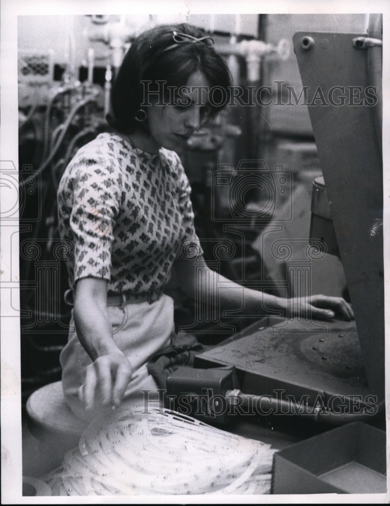 1967 Mrs. Delores Crispin uses stamping press to assemble ball-Historic Images