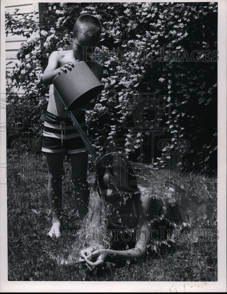 1966 John Lyall and Judy Lyall plays with a pail of water-Historic Images