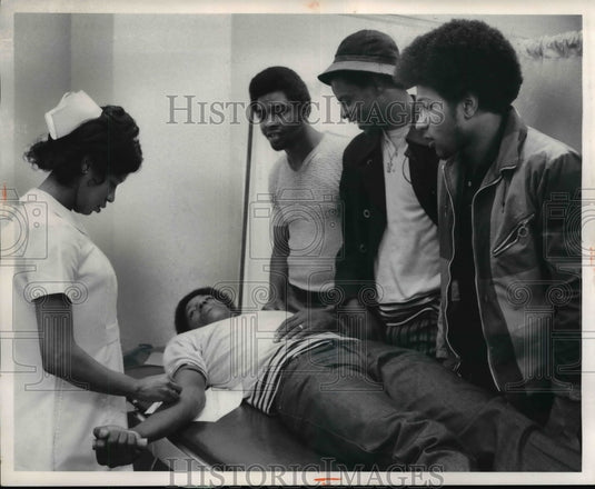 1972 Red Cross nurse gets ready to take blood from Mike St Clair-Historic Images