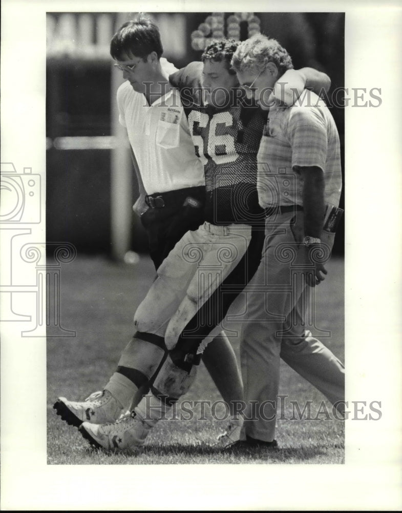 1985 Press Photo J.C. Pelusi is Carried Off Field - cvb39522 - Historic Images