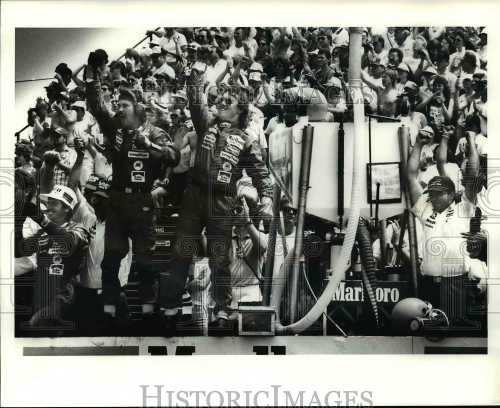 1989 Press Photo Emerson Fittipaldis pitt crew jumps in joy - cvb45516 - Historic Images