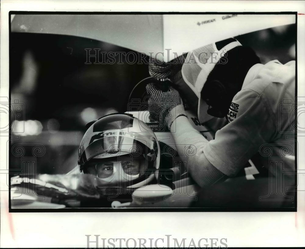 1990 Press Photo Michael Andretti pit crew member holds umbrella over his car- Historic Images