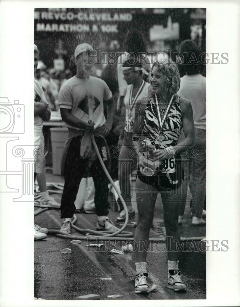 1990 Press Photo Ann Cappelli Stands in Spray of Water at Marathon - cvb49507 - Historic Images