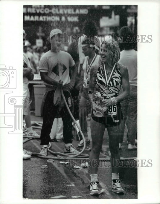 1990 Press Photo Ann Cappelli Stands in Spray of Water at Marathon - cvb49507 - Historic Images