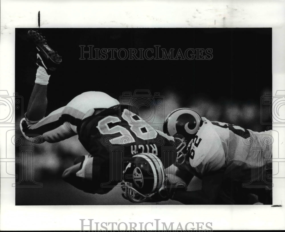 1990 Press Photo Brian Smith Brings Down Mike Rich in First Quarter - cvb54039- Historic Images