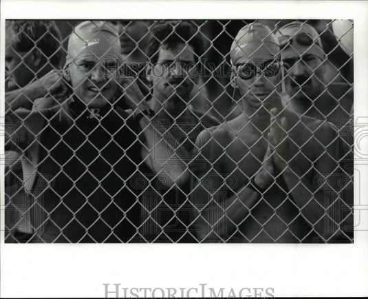 1991 Press Photo: Amateur triatheletes nervously wait their turn to begin swim - Historic Images