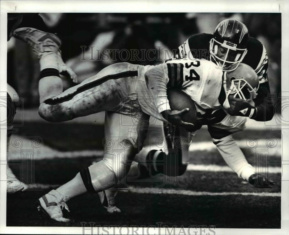 1986 Press Photo Chargers cornerback Ken Taylor grabs Kevin Mack by face mask - Historic Images