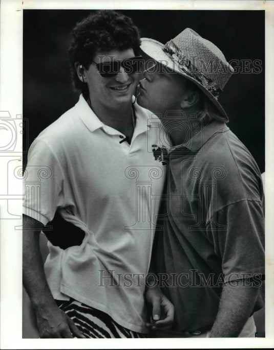 1991 Press Photo Cincinnati Bengal QB Boomer Esiason grabs Bernie Kosar - Historic Images