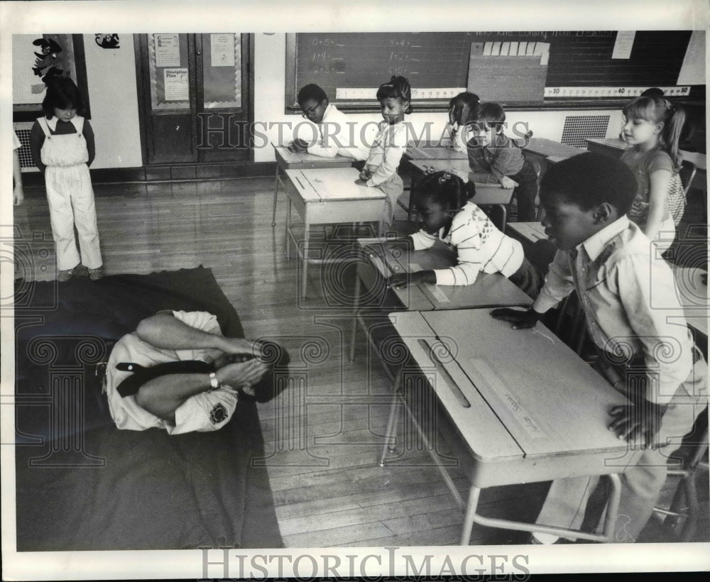 1983, Fire Fighter William A. Petal demonstrate what to do - Historic Images