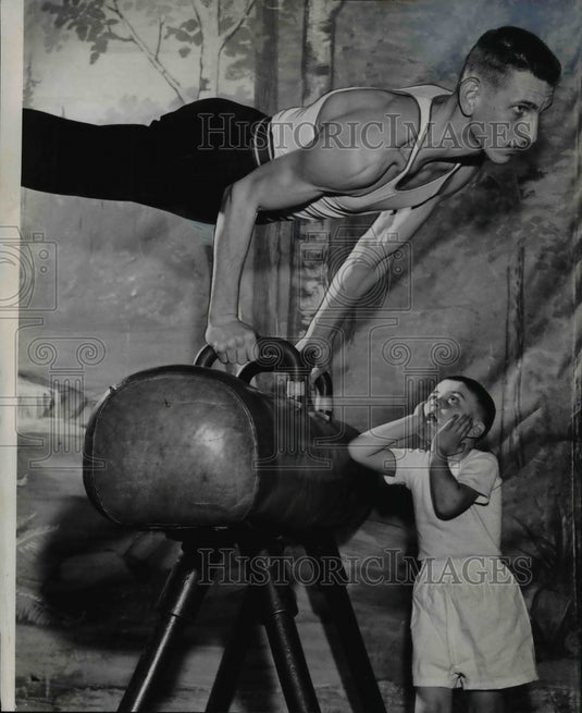 1960 Press Photo Joseph BachÃƒÂ±a performs, while Anthony Milia, 4 watches - Historic Images