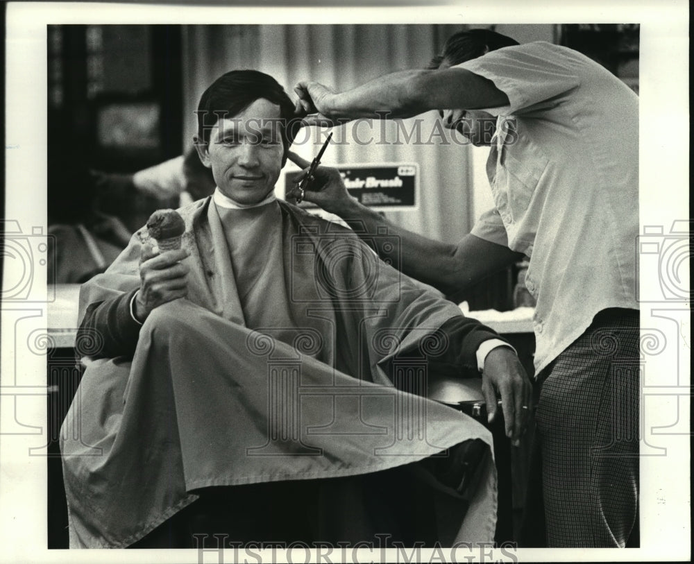 1985, Dennis Kucinich gets his hair trimmed by barber Jim Manfall - Historic Images