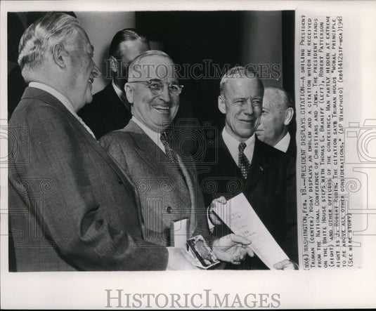 1948, President Truman on White House steps with citation and emblem. - Historic Images