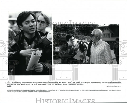 1997, Stanley Tong and Leslie Nielsen on set of Mr. Magoo. - Historic Images