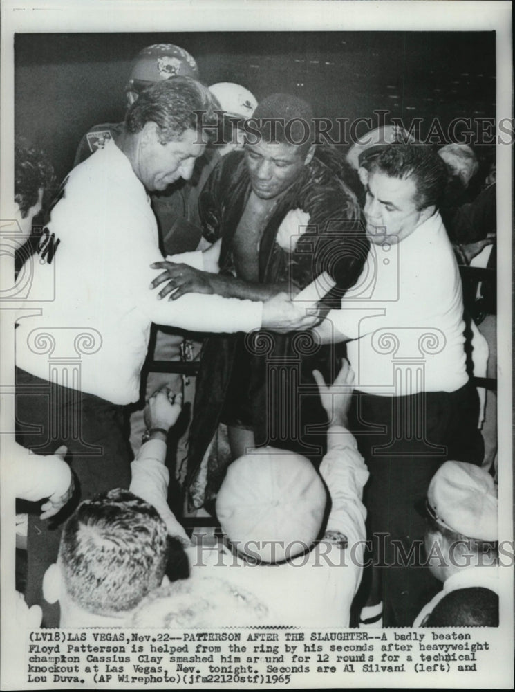 1965 Press Photo Boxer Floyd Patterson Beaten by Cassius Clay Helped Out of Ring - Historic Images