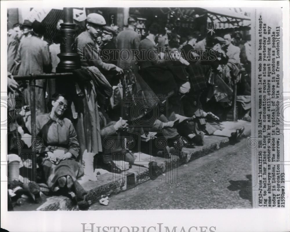 1953 Press Photo A woman at left who has been attempting to hold her place - Historic Images