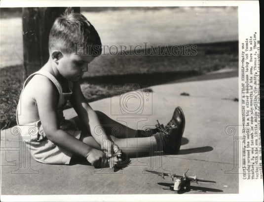 Press Photo Tommie Thurlow Sits Toying with Littlle Ships - Historic Images
