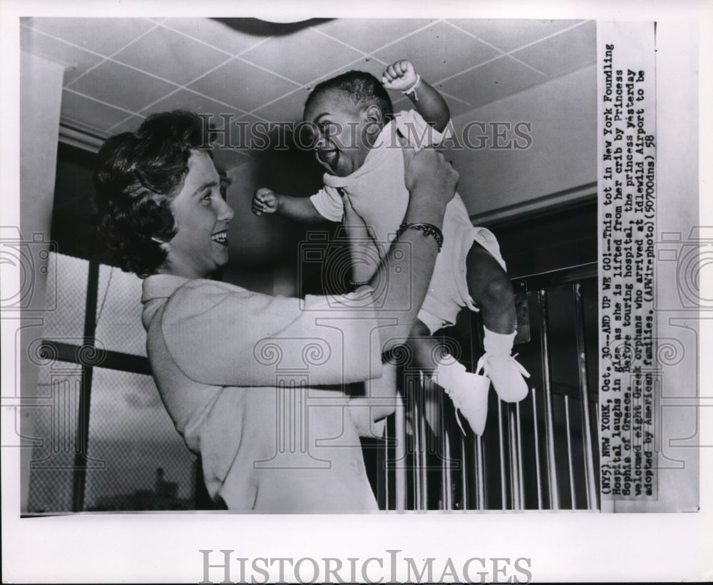 1958 tot in NY Foundling hospital laughs - Historic Images