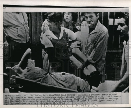 1962 Wire Photo Guatemalan students carry injured girl during rioting - Historic Images