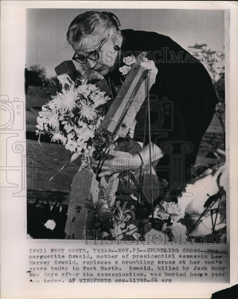 1964 Mrs. M Oswald Replaces a Crumbling Cross at her Son&#39;s Grave - Historic Images