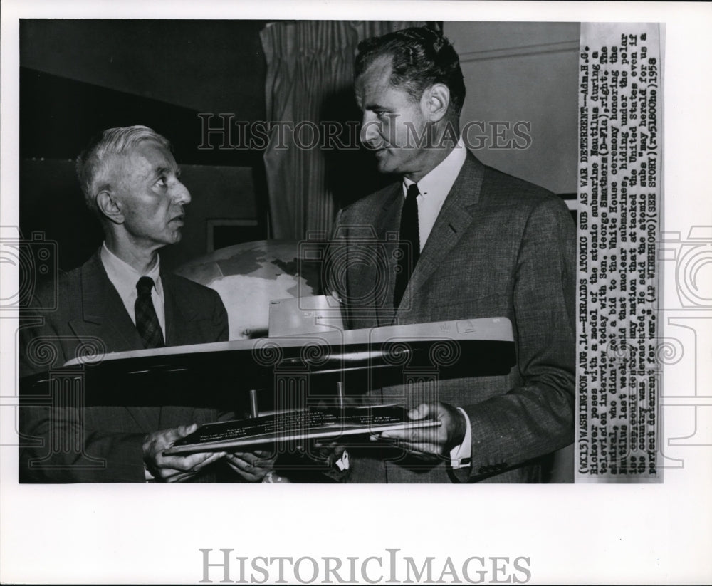 1958 Press Photo Adm. H.G Rickover poses with a model of the atomic submarine - Historic Images