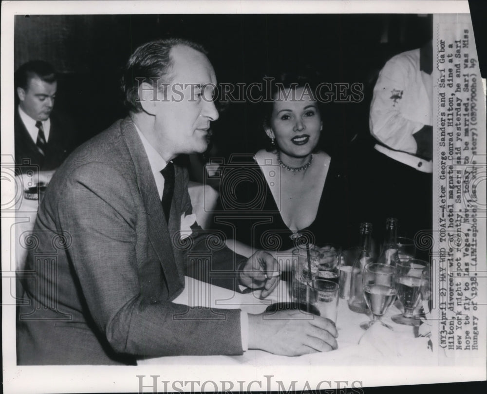 1949 Press Photo Actor Sanders & Hilton dine at New York night spot - Historic Images