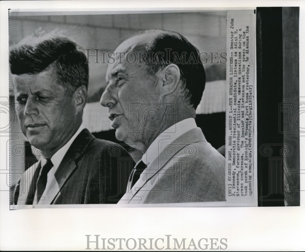 1960 Press Photo Kennedy listens to Stevenson as he answers in press conference - Historic Images