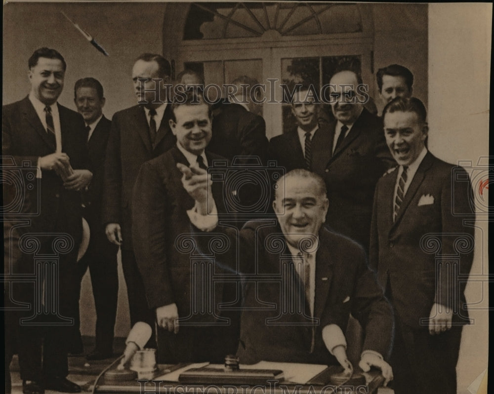 1965 Press Photo Pres. Johnson tosses a pen as he finishes signing at the WH - Historic Images