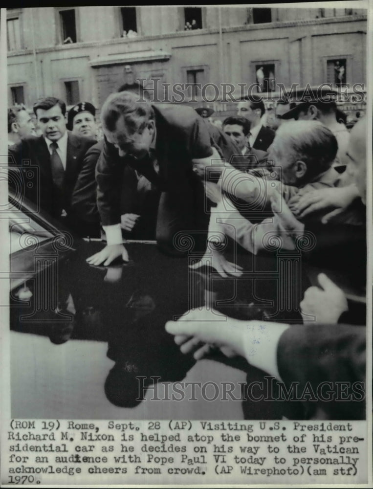 1970 Press Photo Visiting US President Richard M Nixon is helped atop the bonnet - Historic Images