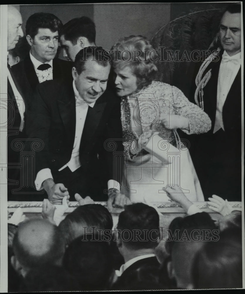 1969 Press Photo Pres Nixon reaches to shake hands while his wife Pat whispers - Historic Images