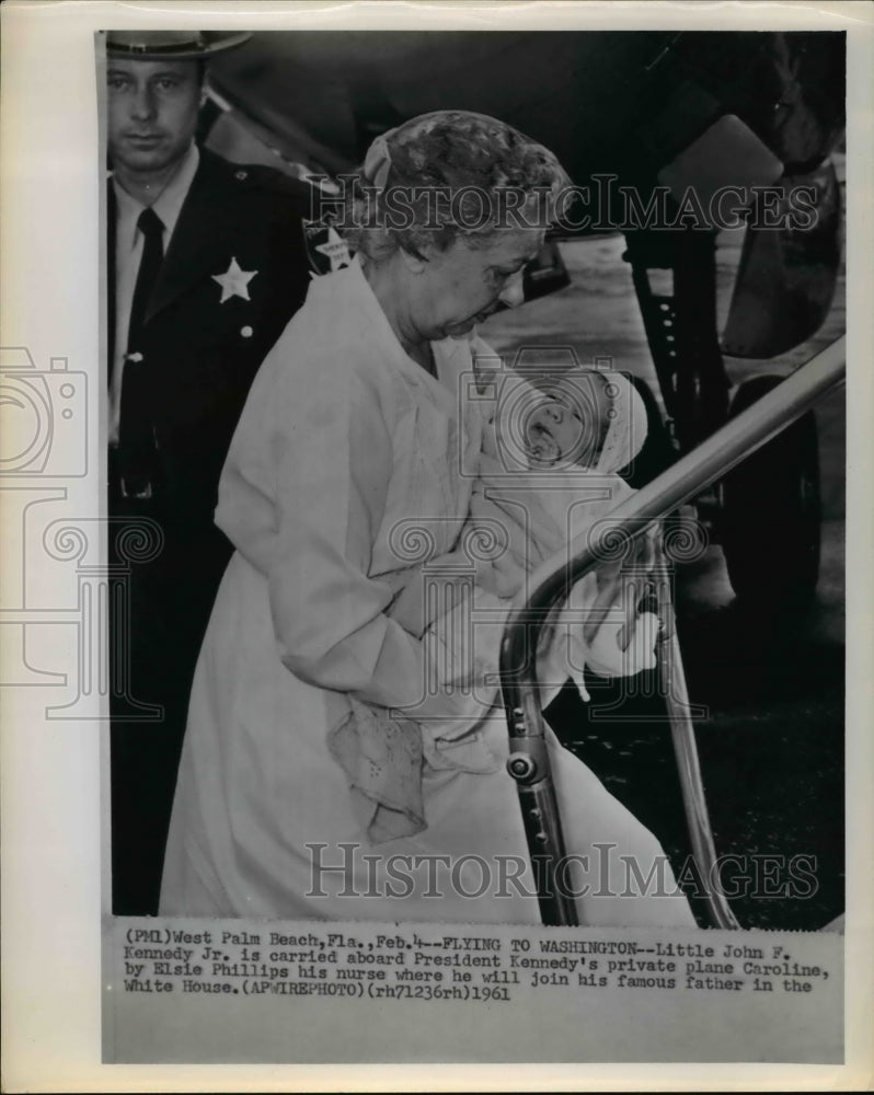 1961 Press Photo Little John Kennedy Jr carried by nurse Elsie Phillips - Historic Images