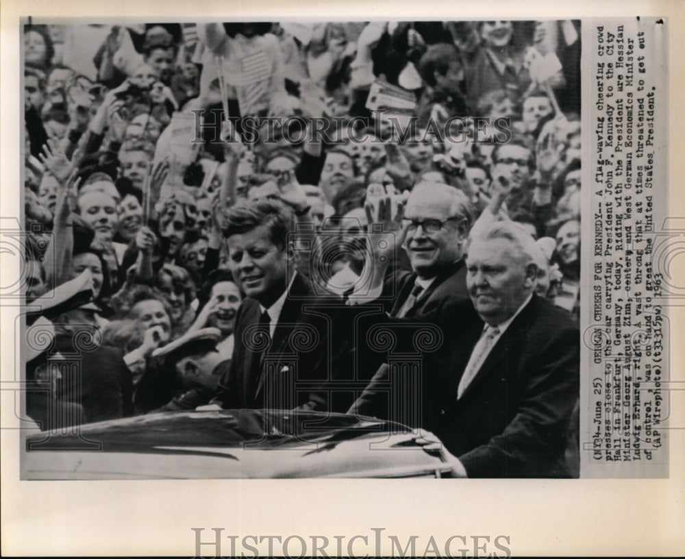 1963 Press Photo A flag-waving cheering crowd presses close to the car carrying - Historic Images