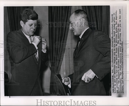 1961 Press Photo Kennedy putting American Legion pin in his coat at White House - Historic Images