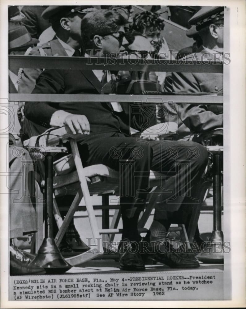 1962 Kennedy in rocking chair watching simulated B52 bomber alert - Historic Images