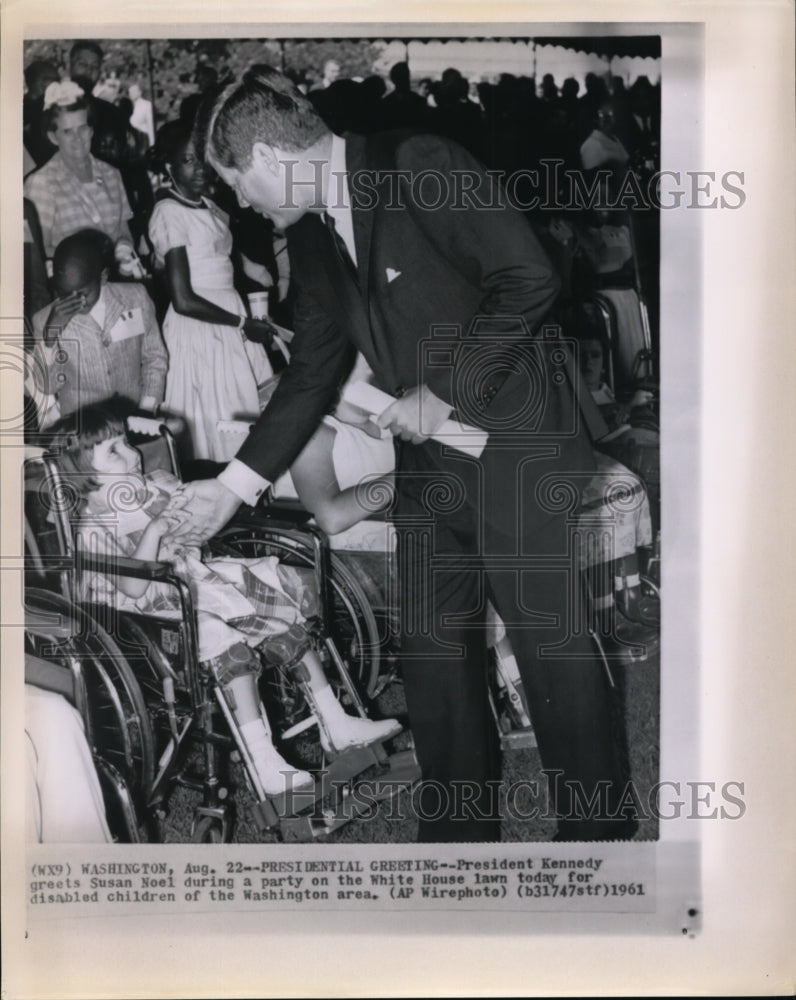 1961 Press Photo Pres Kennedy greets Susan Noel during a party - Historic Images