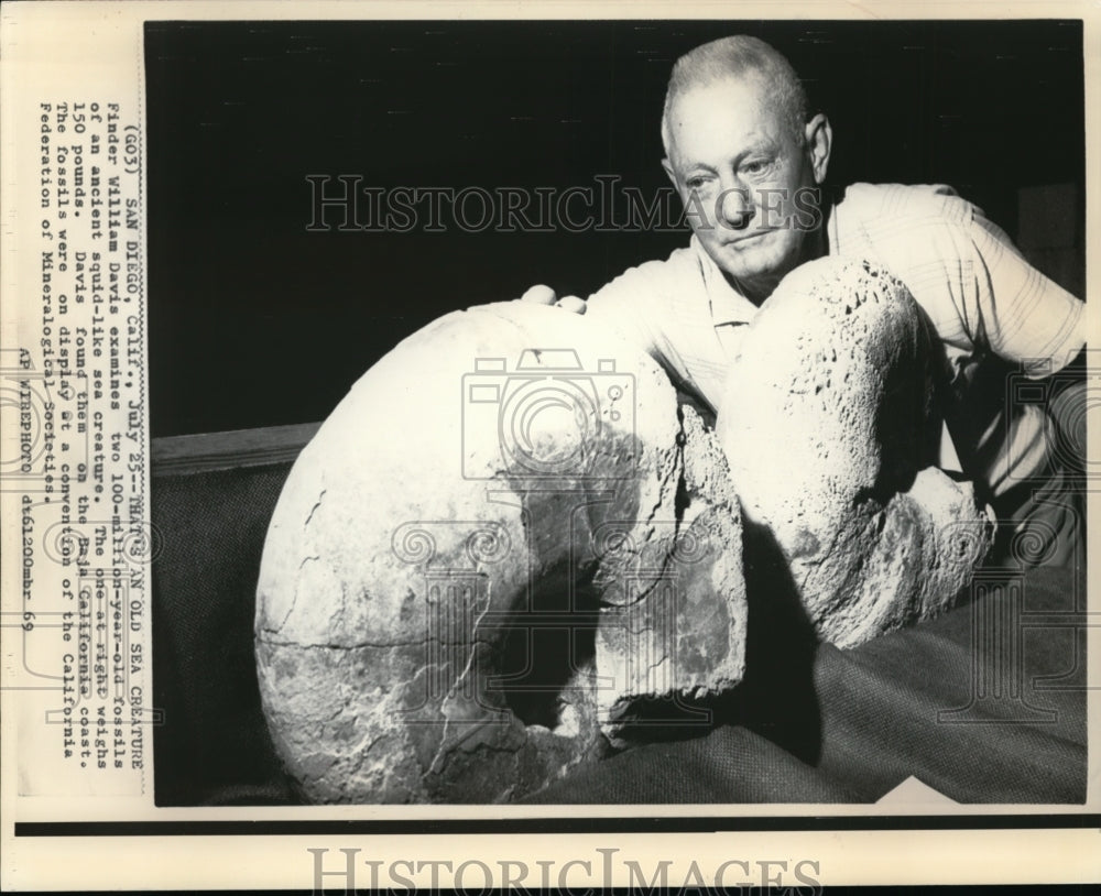 1969 Press Photo William Davies Examines the Two 100 Million Year Old Fossils - Historic Images