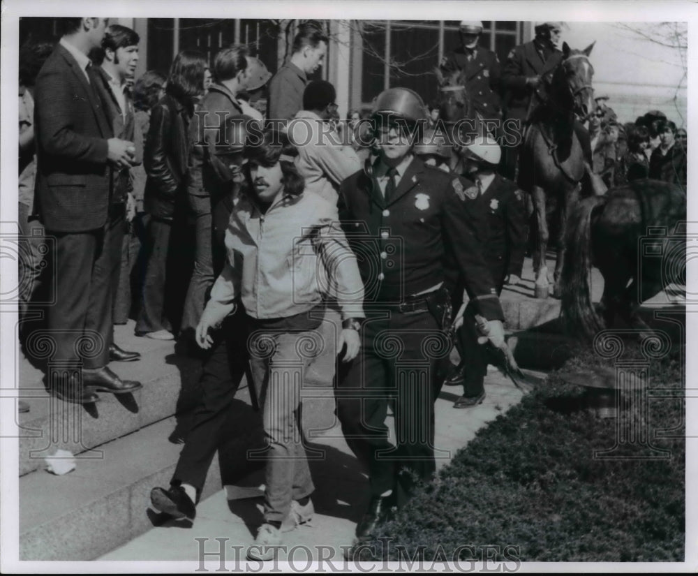 1970 Javon Perry arrested by police at mall during Riot. - Historic Images