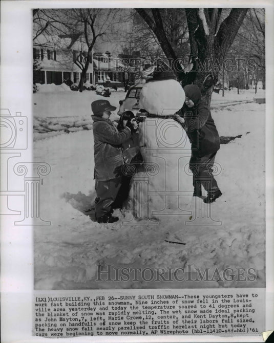 1961 John Dayton & Marie Crowe building snowman in 9 inches of snow - Historic Images