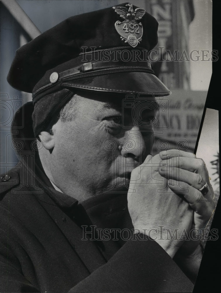 1965 Patrolman John Conway warms hands at E9th- Superior Ave - Historic Images