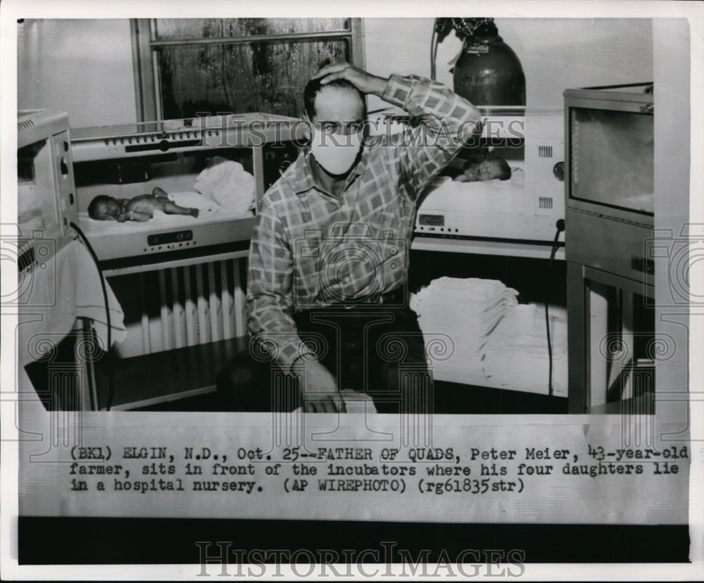 1957 Press Photo Peter Meier sits in front of his quadruplets in a nursery-Historic Images