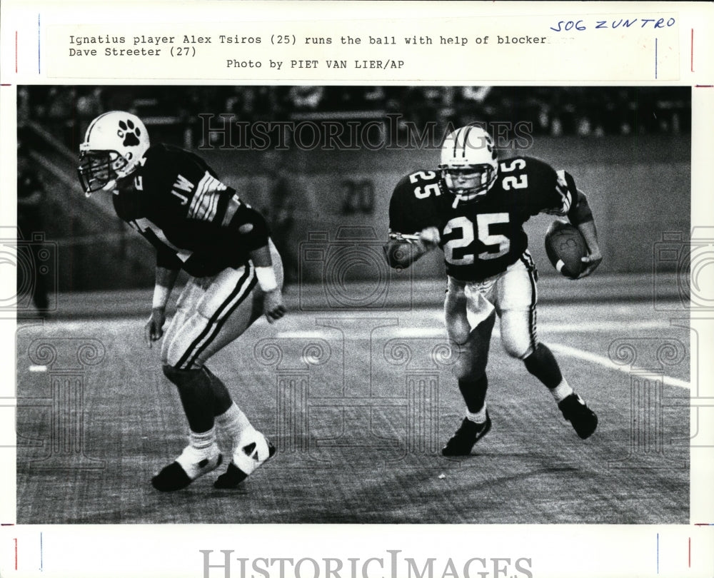 Press Photo Ignatius player Alex Tsiros ran the ball with help of Dave Streeter-Historic Images