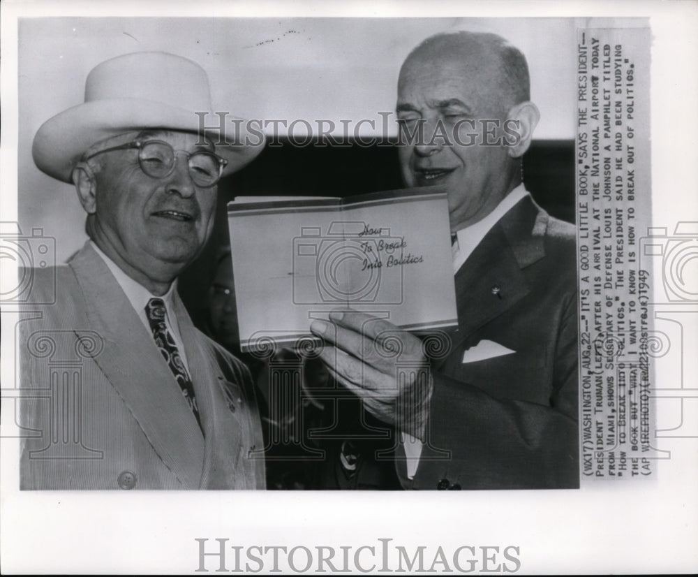 1949 Press Photo Pres. Truman shows a pamphlet to Louis Johnson at airport - Historic Images