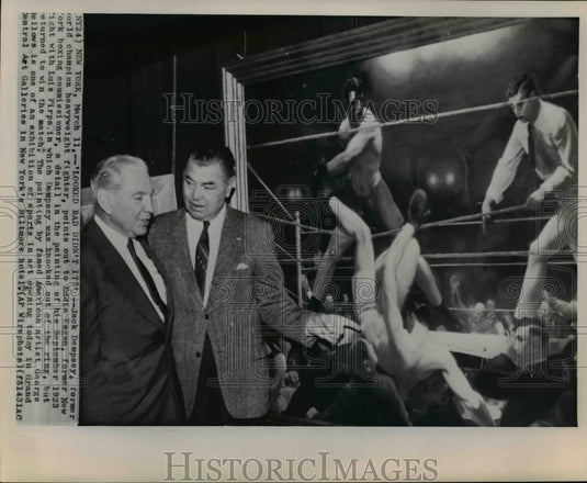 1965 Press Photo Boxing champ Jack Dempsey points out painting to Eddie Eagan - Historic Images