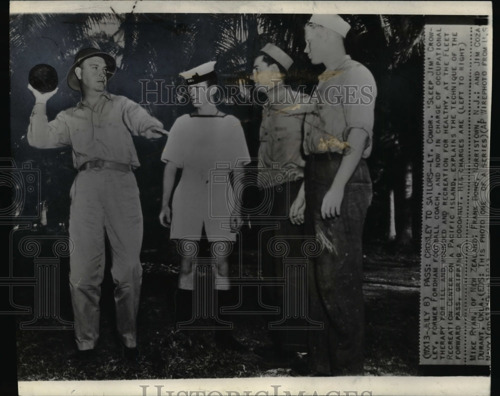 1943 Press Photo Notre Dame star Jimmy Crowley shows a technique using a coconut - Historic Images