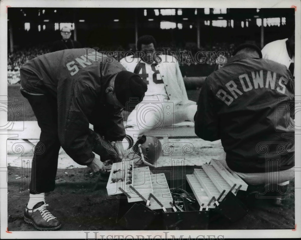 1968 Ernie Seen gets cleat changed during game with the Saints. - Historic Images