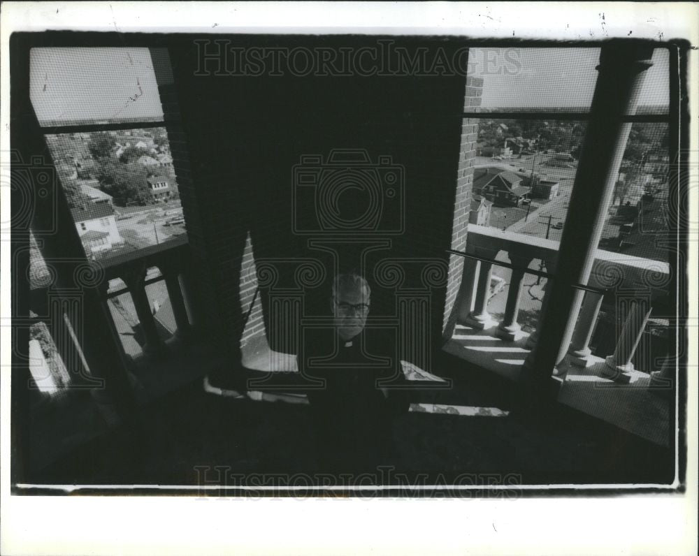 1988 Press Photo Father Fares stands in the bell 1988 - Historic Images