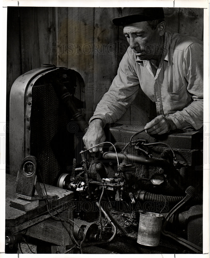 1946 Pete Kurylek tinkers with a motor-Historic Images