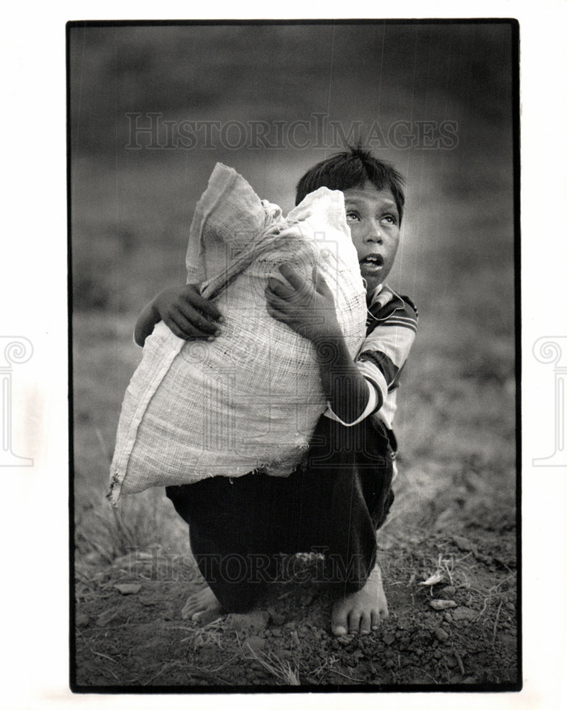 1989 boy listens to his father value grain-Historic Images