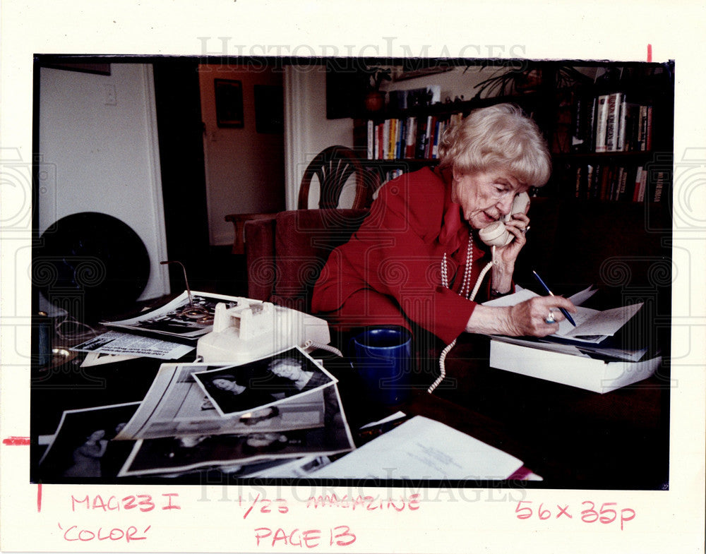 Press Photo Woman Answers Phone Office Desk - Historic Images