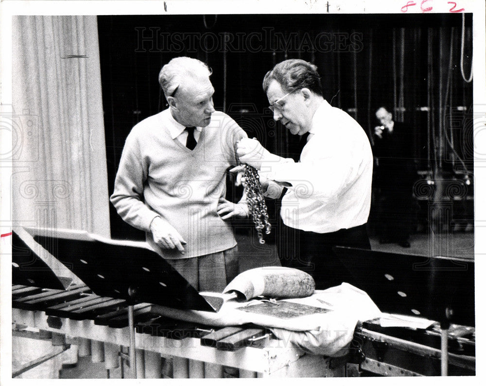 Press Photo Man Inspects Musical Instrument - Historic Images