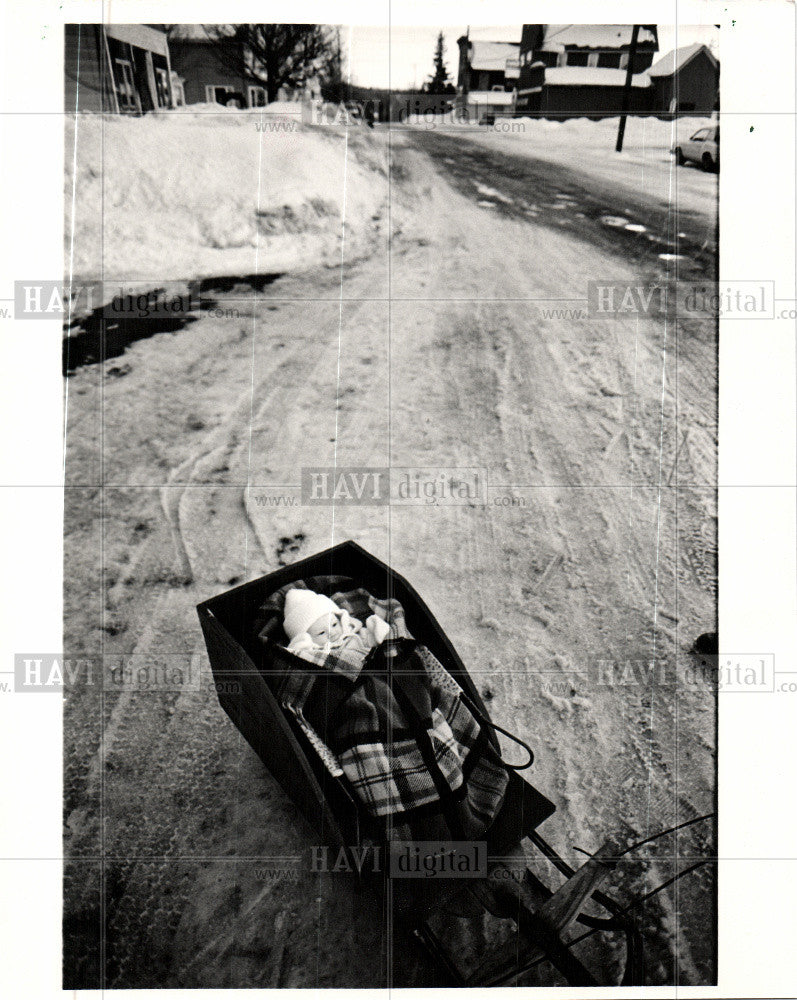 1986 Press Photo 3-month Baby Sled Ride Dollar Bay MI - Historic Images